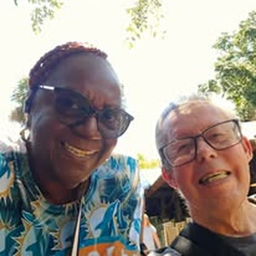 Two individuals smiling together during a day out.