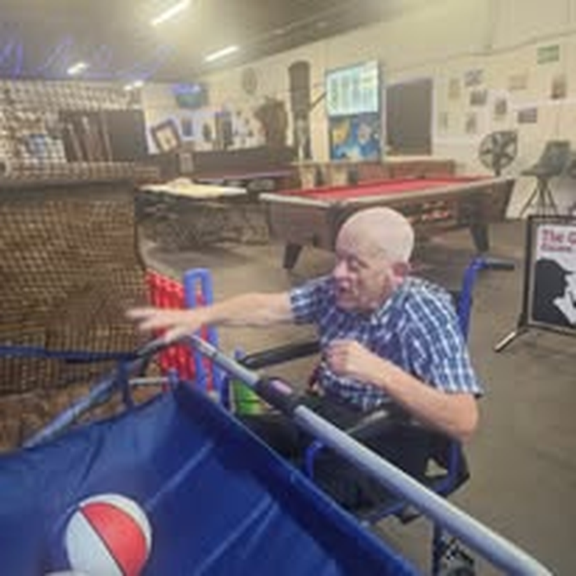 A volunteer focused on his shot at the pool table.
