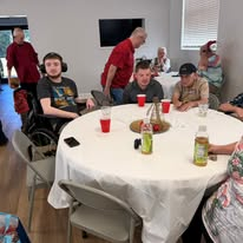 An individual in a wheelchair settling in for the holiday get-together.