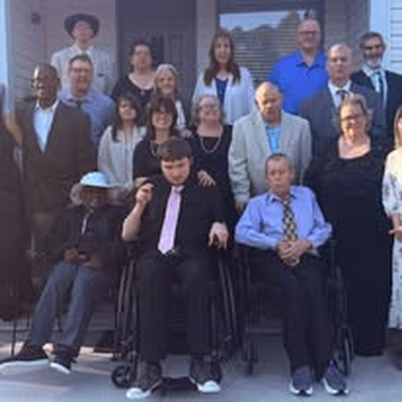 Staff and individuals lined up together for a group portrait.
