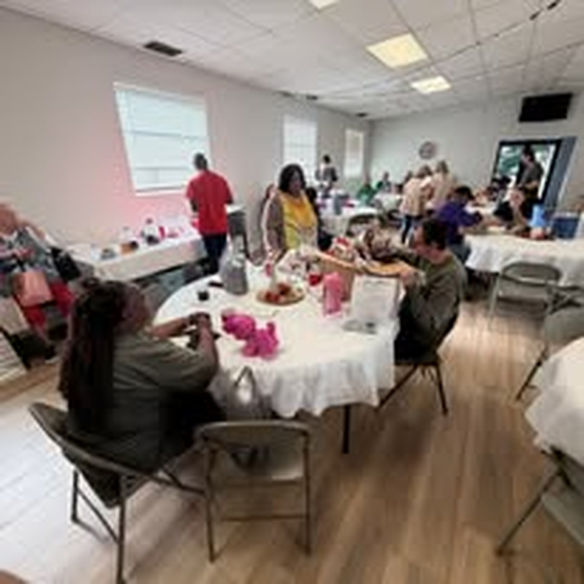 Volunteers setting up tables for a community craft event.