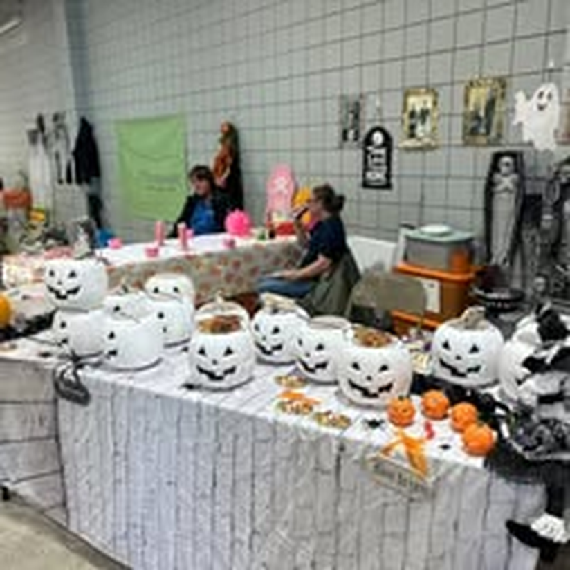 Guests browsing tables at the Halloween craft market.