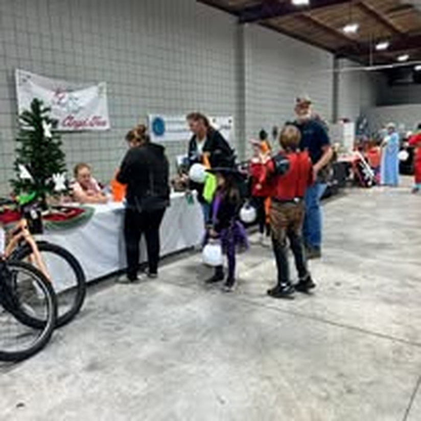 Guests browsing a holiday market with festive decorations.