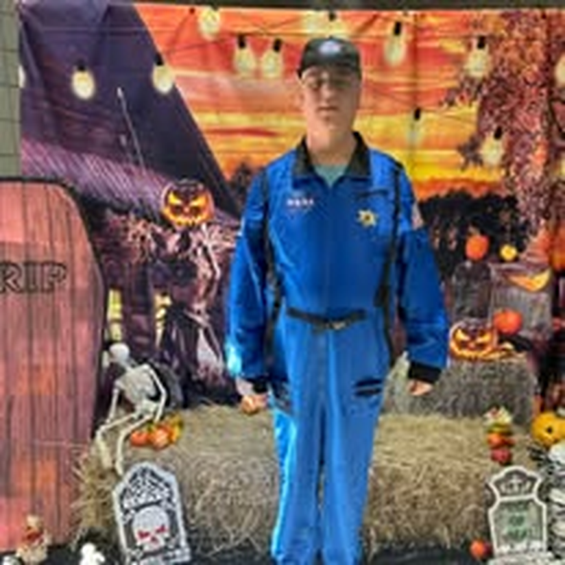 A staff member in an astronaut costume at the Halloween Bash.